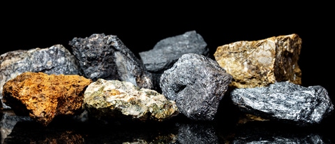 Various raw ore gemstones or rocks on black background, mining and geology, mineralogy