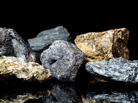 Various raw ore gemstones or rocks on black background, mining and geology, mineralogy